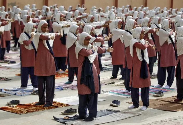 Students practice yoga during a training session ahead of World Yoga Day in Ahmedabad, India, June 16, 2016. (Photo by Amit Dave/Reuters)