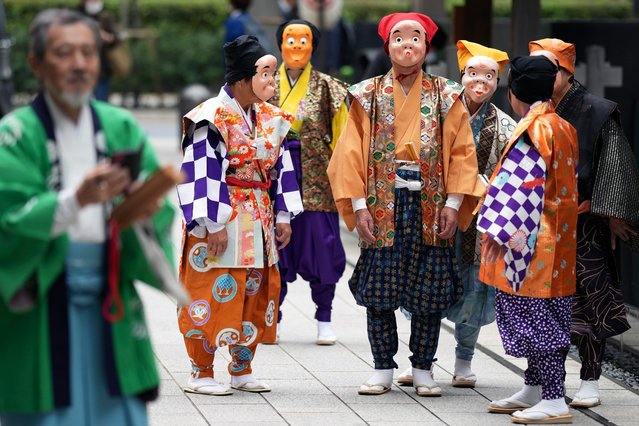 Artists wearing traditional clown masks prepare to march during the annual Shinto festival called the Grand Festival at the Kotohiragu shrine in the Toranomon business district of Tokyo, Thursday, October 10, 2024. (Photo by Eugene Hoshiko/AP Photo)