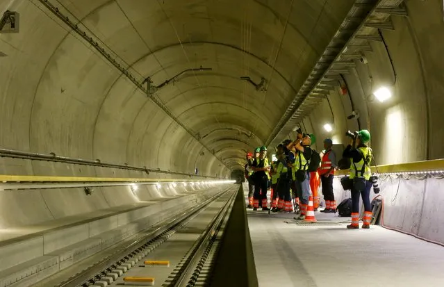 Journalists stand at a multifunction and emergency stop station of the NEAT Gotthard Base Tunnel during a media visit near the town of Sedrun August 24, 2015. (Photo by Arnd Wiegmann/Reuters)