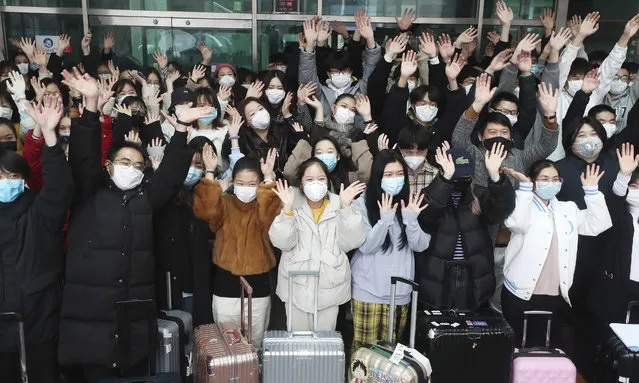 Chinese students wave their hands after they are released from a two-week isolation at a dormitory amid the spread of the coronavirus at the Dankook University in Yongin, South Korea, Tuesday, March 10, 2020. For most people, the new coronavirus causes only mild or moderate symptoms, such as fever and cough. For some, especially older adults and people with existing health problems, it can cause more severe illness, including pneumonia. (Photo by Hong Gi-won/Yonhap via AP Photo)