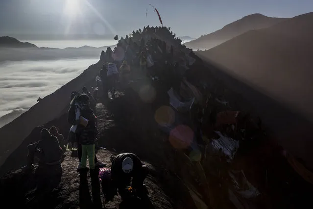 Tenggerese worshippers gather at the crater of Mount Bromo during the Yadnya Kasada Festival on August 12, 2014 in Probolinggo, East Java, Indonesia. (Photo by Ulet Ifansasti/Getty Images)