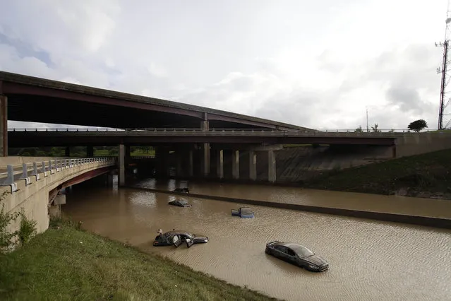 Vehicles sit submerged in water along I-75 August 12, 2014 in Royal Oak, Michigan. Severe rain from yesterday's storm flooded local streets, highways, and homes in the Detroit Metropolitan area experiencing the worst flash flooding in decades. (Photo by Joshua Lott/Getty Images)