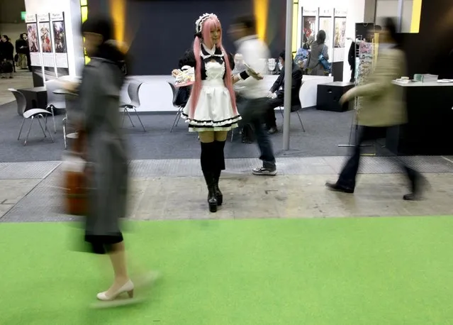 A model dressed in an animation character's costume distributes leaflets to visitors at Tokyo International Anime Fair 2009 in Tokyo in this March 18, 2009 file photo. (Photo by Kim Kyung-Hoon/Reuters)