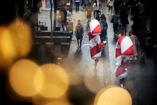 Women dressed as candy canes at Pitt Street Mall in Sydney, Australia, 25 November 2023. Sydney's four-week Christmas celebration in the city center and local neighborhoods kicks off with various markets, concerts, choirs, and illuminations. (Photo by Brent Lewin/EPA)
