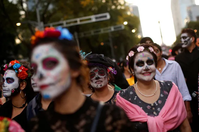 Women dressed up as “Catrina”, a Mexican character also known as “The Elegant Death”, take part in a Catrinas parade in Mexico City, Mexico on October 22, 2017. (Photo by Carlos Jasso/Reuters)