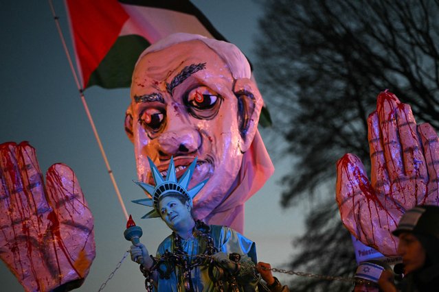 An activist dressed as the Statue of Liberty is pulled in shackles near a large effigy of Israeli Prime Minister Benjamin Netanyahu as they rally in support of Palestinians during the ”Arrest Netanyahu at the White House Rally” near the White House in Washington, DC, on February 4, 2025. Israeli Prime Minister Benjamin Netanyahu met Donald Trump at the White House on February 4 for crucial talks on the truce with Hamas, as the US president suggested permanently resettling Palestinians from war-battered Gaza. (Photo by Mandel Ngan/AFP Photo)