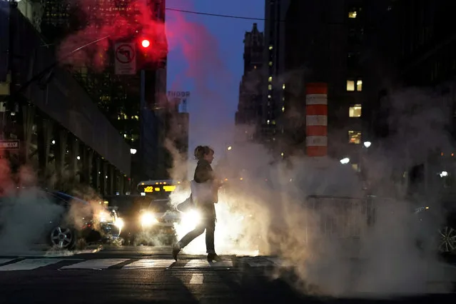 A woman crosses 42nd Street amid steam in the Manhattan borough of New York City, U.S., October 27, 2017. (Photo by Carlo Allegri/Reuters)