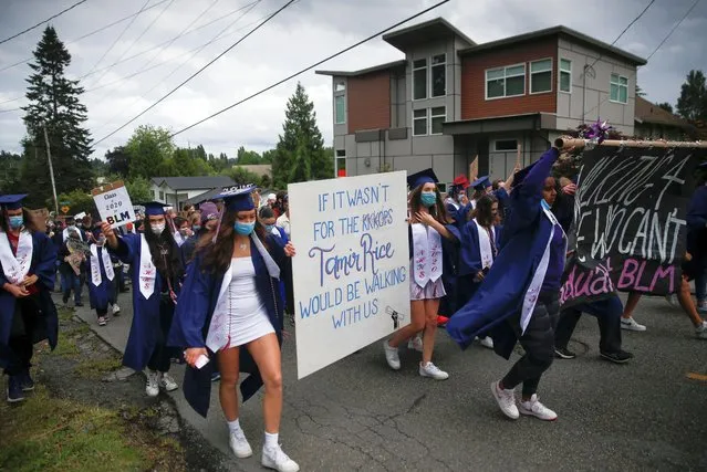Graduates hold a sign referring to Tamir Rice, shot by Cleveland Police in 2014, as Nathan Hale High School seniors join with others to protest against racial inequality in the aftermath of the death in Minneapolis police custody of George Floyd on their graduation day in Seattle, Washington, U.S. June 15, 2020. (Photo by Lindsey Wasson/Reuters)
