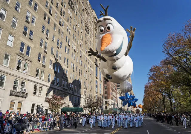 The Olaf balloon glides over Central Park West during the Macy's Thanksgiving Day Parade in New York, Thursday, November 23, 2017. (Photo by Craig Ruttle/AP Photo)