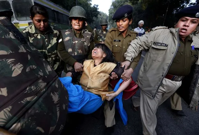 A demonstrator is removed by policemen while protesting against the brutal gang-rape of a woman on a moving bus in New Delhi, India, December 25, 2012. Authorities shut down roads in the heart of India's capital for the second consecutive day to put an end to a week of demonstrations against the gang-rape. (Photo by Saurabh Das/Associated Press)