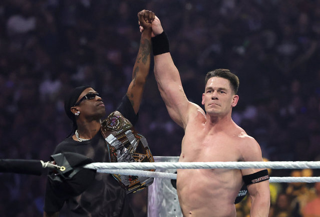 John Cena (R) celebrates with rapper Travis Scott after defeating Cody Rhodes for the Undisputed WWE Championship during WrestleMania 41 at Allegiant Stadium on April 20, 2025 in Las Vegas, Nevada. (Photo by Ethan Miller/Getty Images)