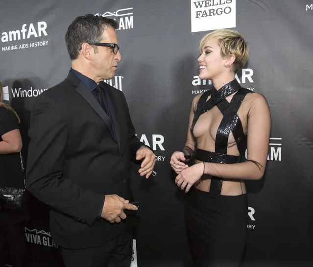 Singer Miley Cyrus greets fashion designer Kenneth Cole at the amfAR's Fifth Annual Inspiration Gala in Los Angeles, California October 29, 2014. (Photo by Mario Anzuoni/Reuters)