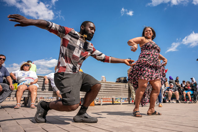 A pair dances salsa on the Coney Island Beach boardwalk on Memorial Day in Brooklyn, New York City, on May 26, 2025. (Photo by Angelina Katsanis/Reuters)