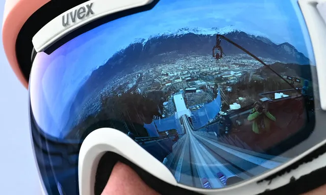 The ski jump reflects in the goggles of Poland's Dawid Kubacki as he waits for his turn during the trial round of the Four Hills FIS Ski Jumping tournament (Vierschanzentournee) in Innsbruck, Austria, on January 3, 2023. (Photo by Christof Stache/AFP Photo) 