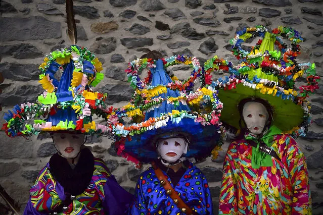 A group of participants dressed in traditional clothes and wearing large hats decorated with ribbons and feathers, known as “Ttutturo”, take part in the Carnival of the Pyrenees villages of Leitza, northern Spain, Tuesday, Jannuary 30, 2018. (Photo by Alvaro Barrientos/AP Photo)