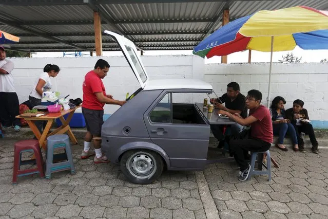 People have breakfast near a polling station n Mixco, Guatemala, October 25, 2015. A former TV comedian with no experience in government is poised to win Guatemala's presidential election on Sunday after a corruption scandal toppled the country's last leader and fuelled voter outrage with the political establishment. Playing up his outsider status and promising clean government, 46-year-old Jimmy Morales has surged in opinion polls since a probe into a multi-million dollar customs racket led to the resignation and arrest of President Otto Perez. (Photo by Jorge Dan Lopez/Reuters)