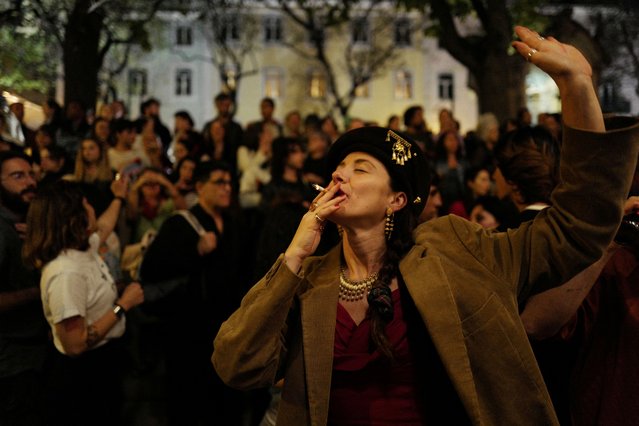 A woman dances in Carmo square as Portugal celebrates the 50th anniversary of the 1974 Carnation Revolution, which ended Europe's longest dictatorship, in Lisbon, Portugal on April 24, 2024. (Photo by Pedro Nunes/Reuters)