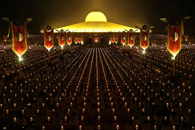 Thousands of believers join Buddhist monks praying at the Wat Phra Dhammakaya temple during a ceremony on Makha Bucha Day in Pathum Thani, Thailand, March 1, 2018. (Photo by Athit Perawongmetha/Reuters)