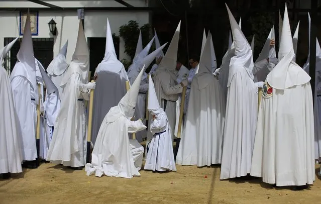 Penitents of “La Paz” (The Peace) brotherhood wait before their penance during Holy Week in the Andalusian capital of Seville, southern Spain, March 24, 2013. Hundreds of Easter processions take place around the clock in Spain during Holy Week, drawing thousands of visitors. (Photo by Marcelo del Pozo/Reuters)