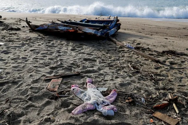 A piece of the boat and a piece of clothing from the deadly migrant shipwreck are seen in Steccato di Cutro near Crotone, Italy on February 28, 2023. (Photo by Remo Casilli/Reuters)