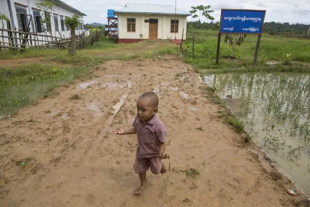 A boy runs barefoot as he plays in front of a clinic which was donated by China's oil pipeline project on Madae island, Kyaukpyu township, Rakhine state, Myanmar October 7, 2015. (Photo by Soe Zeya Tun/Reuters)