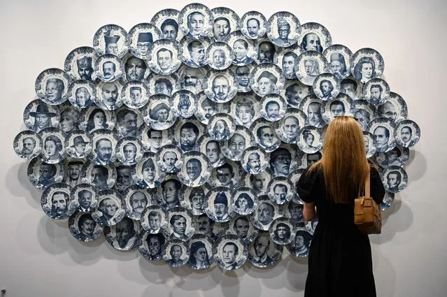 A visitor looks at an artwork called “Bon Appetite” by Spanish artist Carlos Aires at Art Basel in Hong Kong on March 23, 2023. (Photo by Peter Parks/AFP Photo)