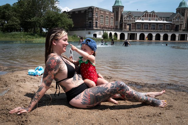 Natasha Bertram cools off with her daughter Pepper at the beach in Humboldt Park on June 17, 2024 in Chicago, Illinois. Temperatures in the city are expected to hit near a record today as they reach into the mid to high 90 degree range. Daily high temperatures are expected to remain in the 90s in the city for the remainder of the week.  (Photo by Scott Olson/Getty Images)