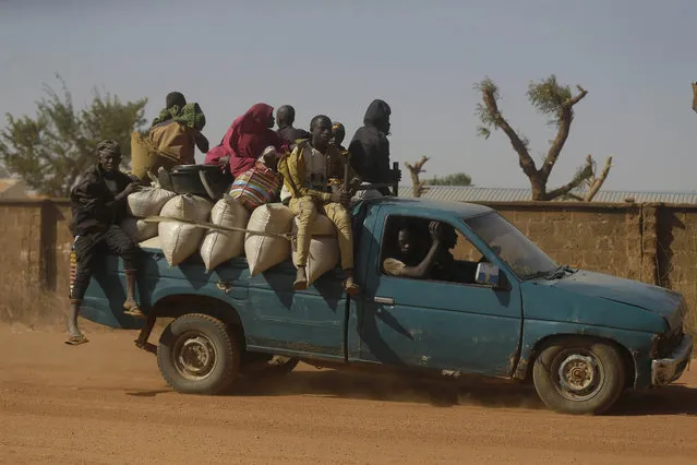 People travel past Government Science Secondary School in Kankara, Nigeria, Tuesday, December 15, 2020. (Photo by Sunday Alamba/AP Photo)
