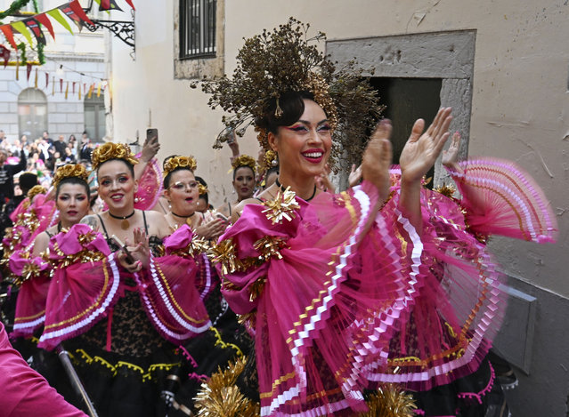 Dancers of Marcha de Bica are seen dressed in costume in the old quarter of Bica before leaving to parade in Avenida da Liberdade on June 12, 2024 in Lisbon, Portugal. Bica is one of the historic neighborhoods filled up with food and drink stalls during celebrations on the eve of Santo Antonio day, dedicated to the Patron Saint of Lisbon, a very important attraction for locals and tourists alike. (Photo by Horacio Villalobos/Corbis via Getty Images)