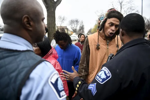A protester argues with a police officer in front of a north Minneapolis police precinct during a protest in response of Sunday's shooting death of Jamar Clark by police officers in Minneapolis, Minnesota, November 18, 2015. (Photo by Craig Lassig/Reuters)