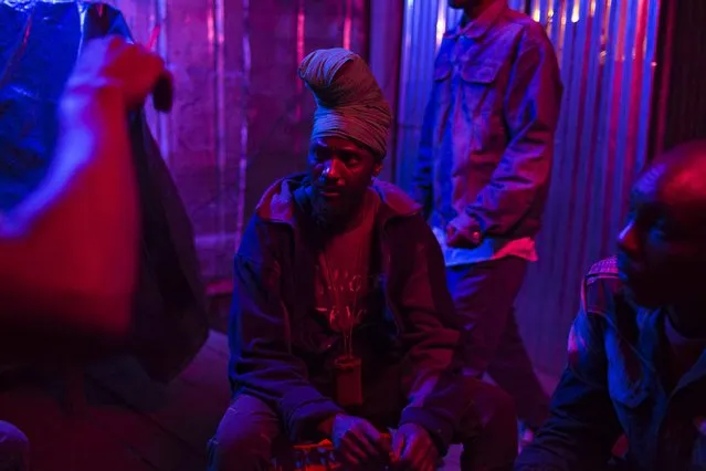 Men socialise in a local bar in Majengo in Nairobi, Kenya, April 24, 2015. (Photo by Siegfried Modola/Reuters)