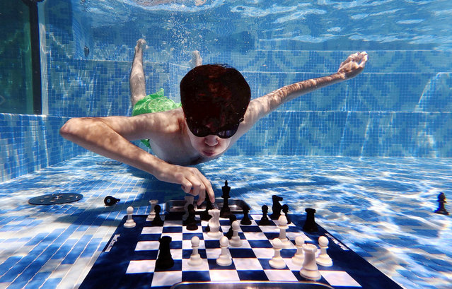 Uzbekistan's Javokhir Sindarov in action against Hans Niemann of the U.S. during the Diving Chess Competition in Cape Town, South Africa, on December 4, 2025. (Photo by Esa Alexander/Reuters)