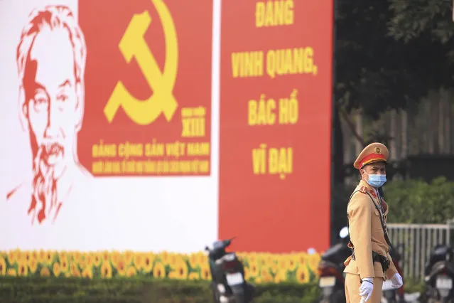 A police officer directs traffic in front of the National Convention Center in Hanoi, Vietnam, Saturday, January 23, 2021. Almost 1,600 leading members of Vietnam's Communist Party on Tuesday, Jan. 26, 2021, begin a meeting to set policy for the next five years and select the group's senior members to steer the nation. (Photo by Hau Dinh/AP Photo)