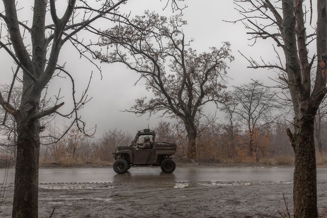 A Ukrainian soldier drives a vehicle on a road leading to the town of Chasiv Yar, in Kostyantynivka, eastern Donetsk region, on December 10, 2024, amid the Russian invasion of Ukraine. A missile strike killed two and wounded more than a dozen in the southern Ukrainian city of Zaporizhzhia, officials said on December 10. Southern Ukraine has seen intensified strikes this autumn, reinforcing fears of a new Russian offensive in the area. (Photo by Roman Pilipey/AFP Photo)