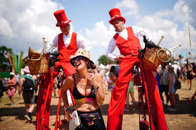 A festivalgoer enjoys the weather in the circus area at the Glastonbury Festival at Worthy Farm in Somerset, United Kingdom on Thursday, June 22, 2023. (Photo by Ben Birchall/PA Images via Getty Images)