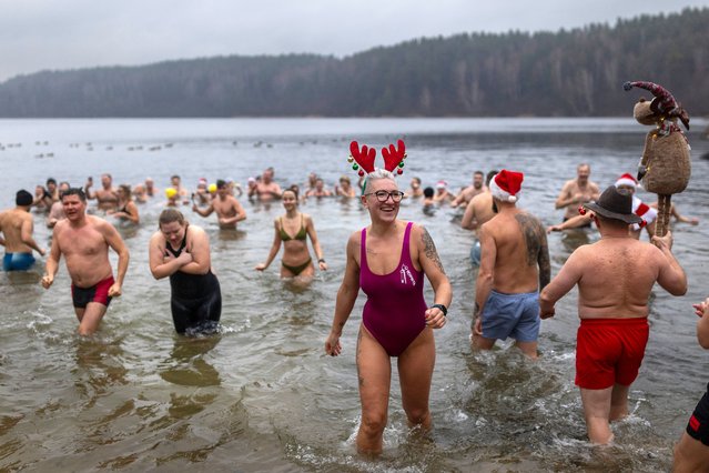 Swimmers enter the water during the traditional New Year's Dive in a lake near Vilnius, Lithuania, Wednesday, January 1, 2025. (Photo by Mindaugas Kulbis/AP Photo)