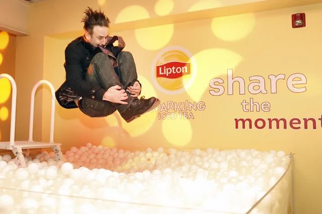Actor David Arquette cannonballs into the bubble pit at the Lipton Sparkling Iced Tea Lounge in Park City, Utah on Friday, January 23, 2015. (Photo by Allison Yin/Invision for Lipton/AP Images)