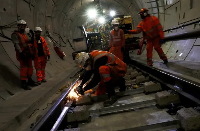 Workers lay railway track in a tunnel of the Crossrail project in Stepney, east London, Britain, November 16, 2016. (Photo by Stefan Wermuth/Reuters)