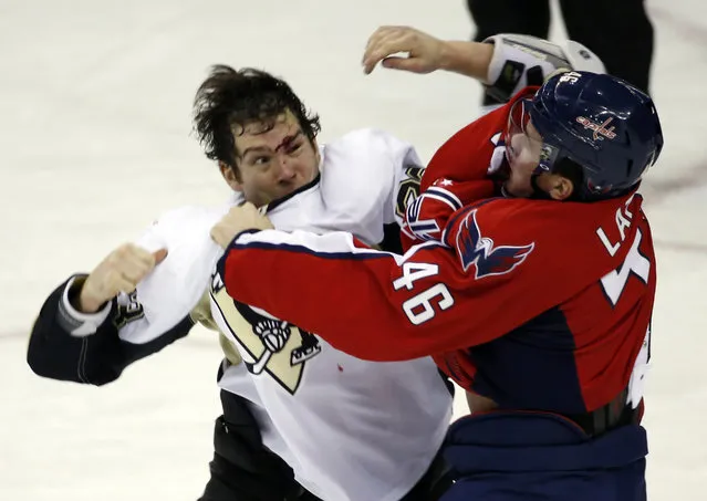 Pittsburgh Penguins right wing Steve Downie (23) and Washington Capitals center Michael Latta (46) fight in the third period of an NHL hockey game, Wednesday, January 28, 2015, in Washington. The Capitals won 4-0. (Photo by Alex Brandon/AP Photo)