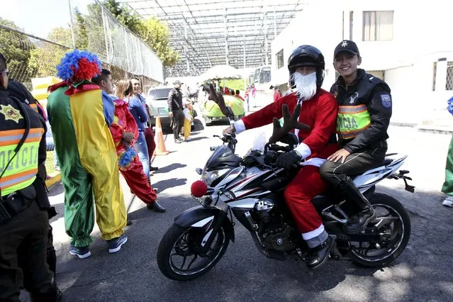 A police officer in a Santa Claus outfit rides a motorcycle during a Christmas event for street children in Quito December 22, 2015. (Photo by Guillermo Granja/Reuters)