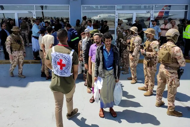 Freed Houthi prisoners stand as they wait to board an International Committee of the Red Cross (ICRC)-chartered plane at Aden Airport, in Aden, Yemen on April 14, 2023. (Photo by Fawaz Salman/Reuters)