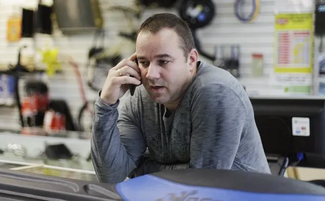 Fabian Zakharov speaks with a client from Cuba using his cellphone in his Zakharov Auto Parts shop in Hialeah, Florida, February 4, 2015. Zakharov, 40, is Miami's go-to man for visiting Cubans or those with family on the island who need parts for the thousands of Russian-made Ladas and Moskvichs that dominate the country's cracked streets, alongside Fords and Chevys dating back to the 1950s. (Photo by Javier Galeano/Reuters)