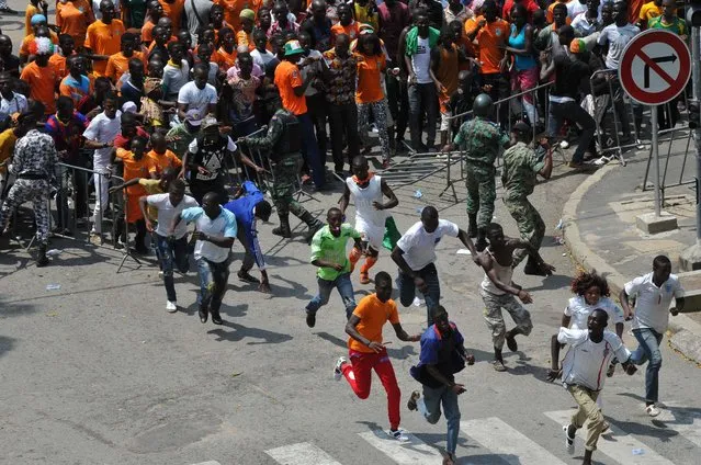 Supporters of Ivorian football national team force a police barrier to enter the Houphouet Boigny stadium in Abidjan on February 9, 2015 to welcome their team a day after its victory over Ghana in the 2015 African Cup of Nations final. (Photo by Sia Kambou/AFP Photo)