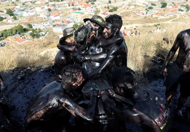 Revellers put grease on their bodies as they take part in the annual Cascamorras festival in Baza, southern Spain on September 6, 2018. The festival was inspired by a dispute between the town of Baza and Guadix over the possession of an icon of the Virgin of Piedad. The Cascamorras refers to representatives from Guadix, who were sent to Baza to recover the statue. As the Cascamorras had to stay perfectly clean to gain possession of the statue, Baza residents attempt to make them as 'dirty' as possible. (Photo by Jon Nazca/Reuters)