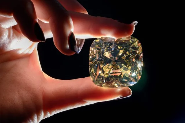 A picture taken on May 6, 2022 in Geneva shows “The Red Cross Diamond” a 205,07 carats fancy intense yellow, cushion-shaped diamond that will be offered on May 11, 2022 in Geneva by Christie’s auction house. Part of the proceeds of the sale of the diamond will benefit the International Committee of the Red Cross. (Photo by Fabrice Coffrini/AFP Photo)
