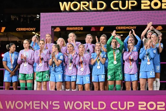 England's players stand on the podium after receiving the runners up medals at the end of the Australia and New Zealand 2023 Women's World Cup final football match between Spain and England at Stadium Australia in Sydney on August 20, 2023. (Photo by William West/AFP Photo)