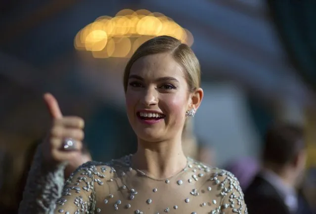 Cast member Lily James gestures at the premiere of "Cinderella" at El Capitan theatre in Hollywood, California March 1, 2015. The movie opens in the U.S. on March 13. REUTERS/Mario Anzuoni  (UNITED STATES - Tags: ENTERTAINMENT HEADSHOT PROFILE)