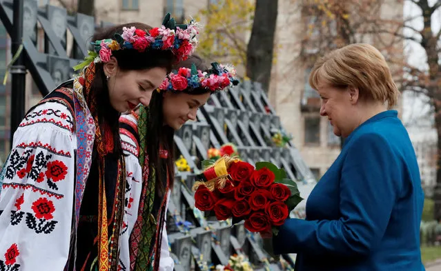 German Chancellor Angela Merkel lays flowers at a monument commemorating the so-called “Heavenly Hundred”, the anti-government protesters killed during the Ukrainian pro-European Union (EU) mass demonstrations in 2014, in Kiev, Ukraine on November 1, 2018.. (Photo by Valentyn Ogirenko/Reuters)