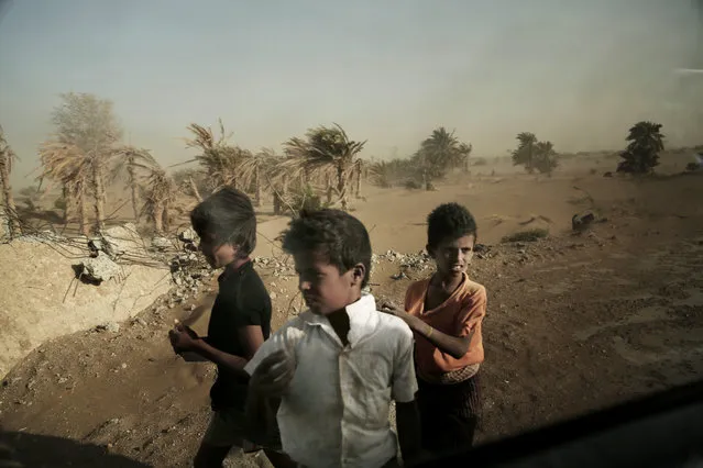 In this February 12, 2018 file photo, homeless children stand on the road in Hodeida, Yemen. With US backing, the United Arab Emirates and its Yemeni allies have restarted their all-out assault on Yemen’s port city of Hodeida, aiming to wrest it from rebel hands. Victory here could be a turning point in the 3-year-old civil war, but it could also push the country into outright famine. Already, the fighting has been a catastrophe for civilians on the Red Sea coast. (Photo by Nariman El-Mofty/AP Photo)