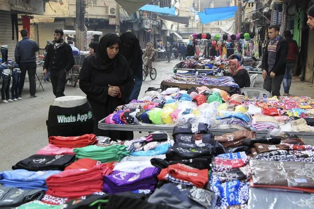 Women shop in a clothes market in Aleppo January 22, 2015. The al Qaeda-linked Nusra Front implemented a new law in Aleppo where mannequins faces are not allowed to be shown, activists said. (Photo by Jalal Al-Mamo/Reuters)